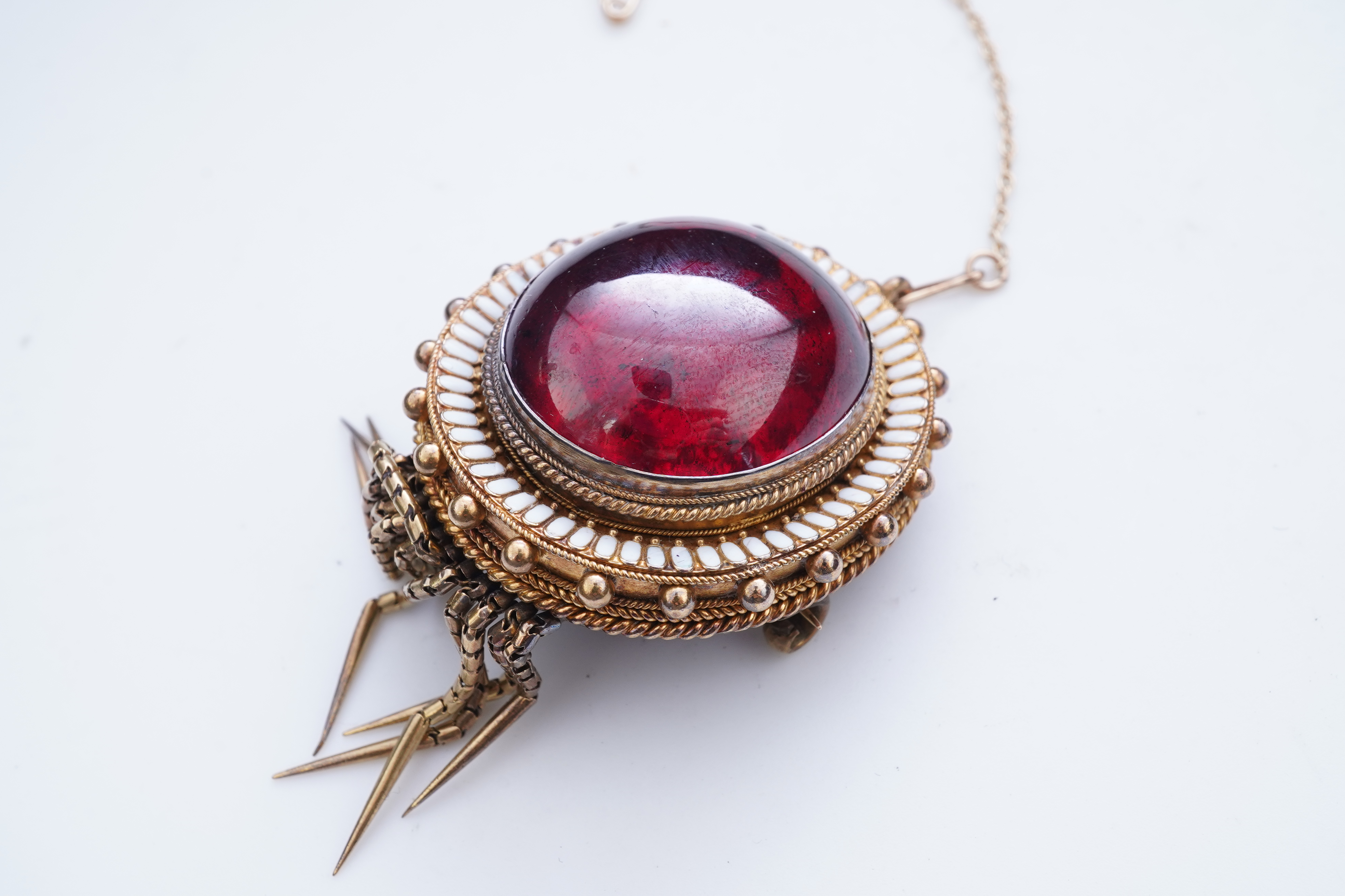 A Victorian garnet and enamel brooch, mid 19th century